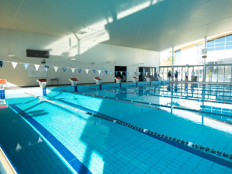 The length of the main pool under the skylights, with pennants strung across the lanes